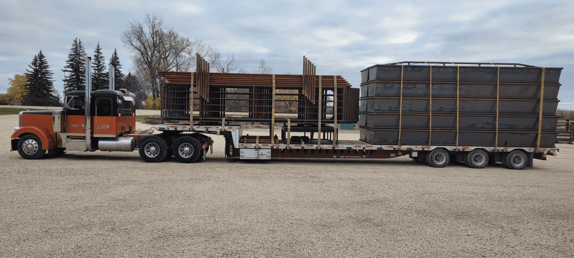 A semi truck with its trailer loaded down.